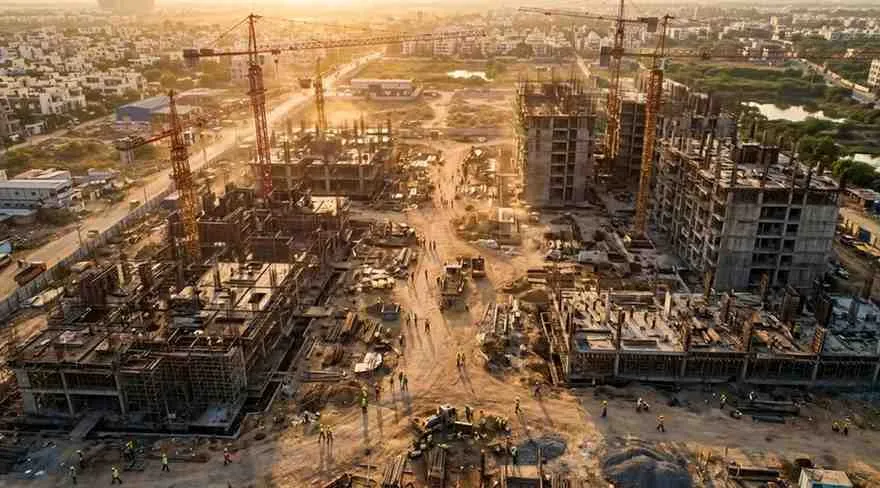 Indian construction site workers in PPE gear representing OSHA safety standards compliance in infrastructure projects